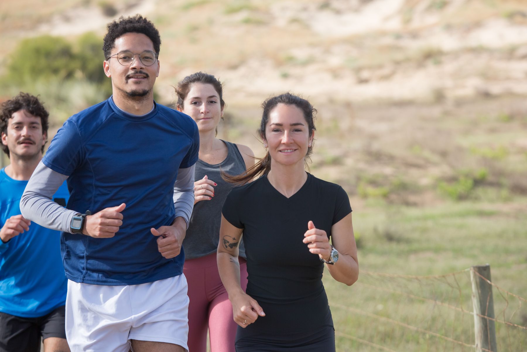 A diverse group of friends jogging together outdoors in Portugal